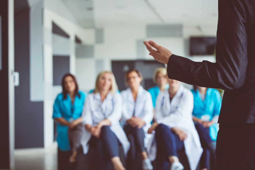 Woman giving a speech on seminar for doctors